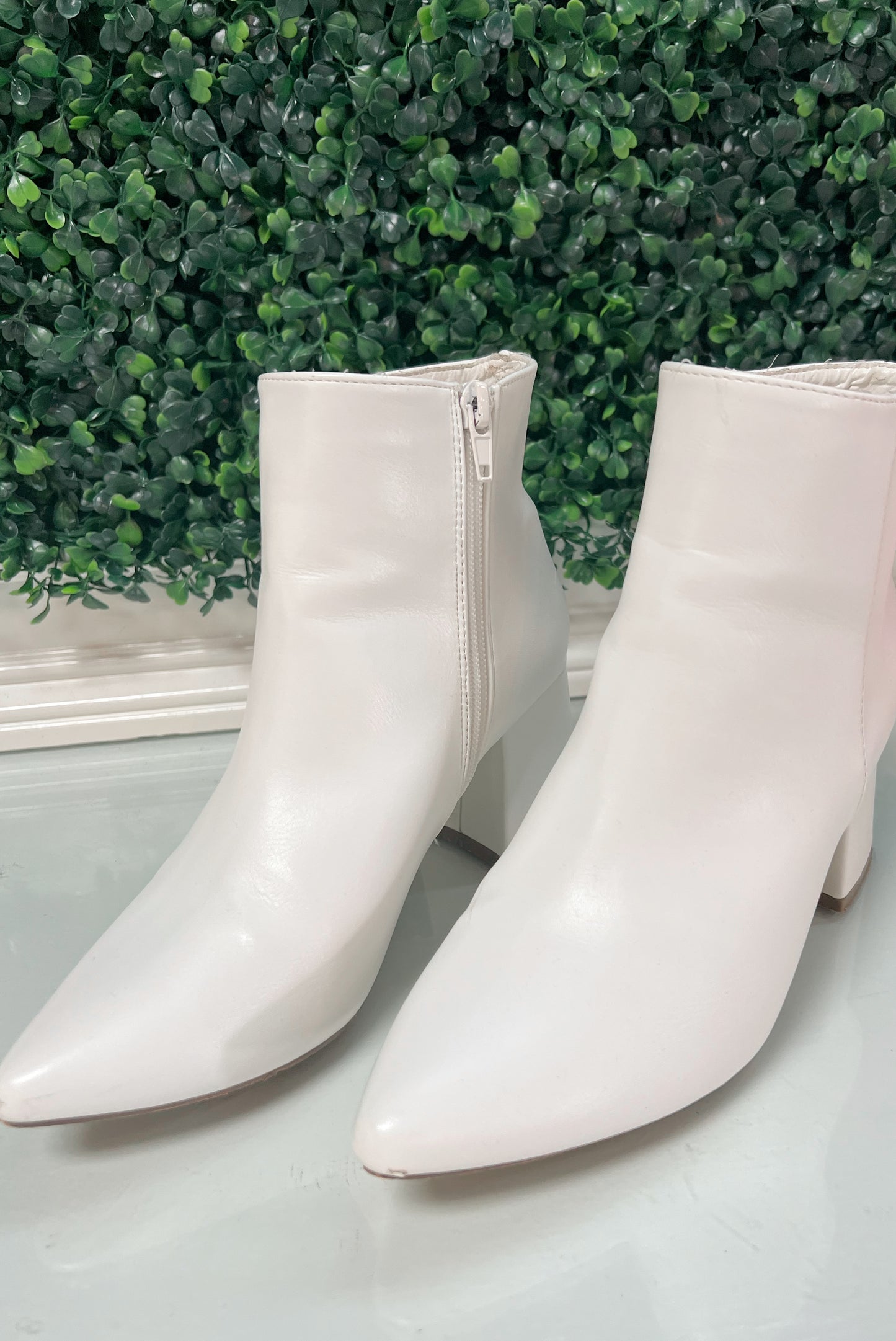 White heeled ankle booties with inside zipper