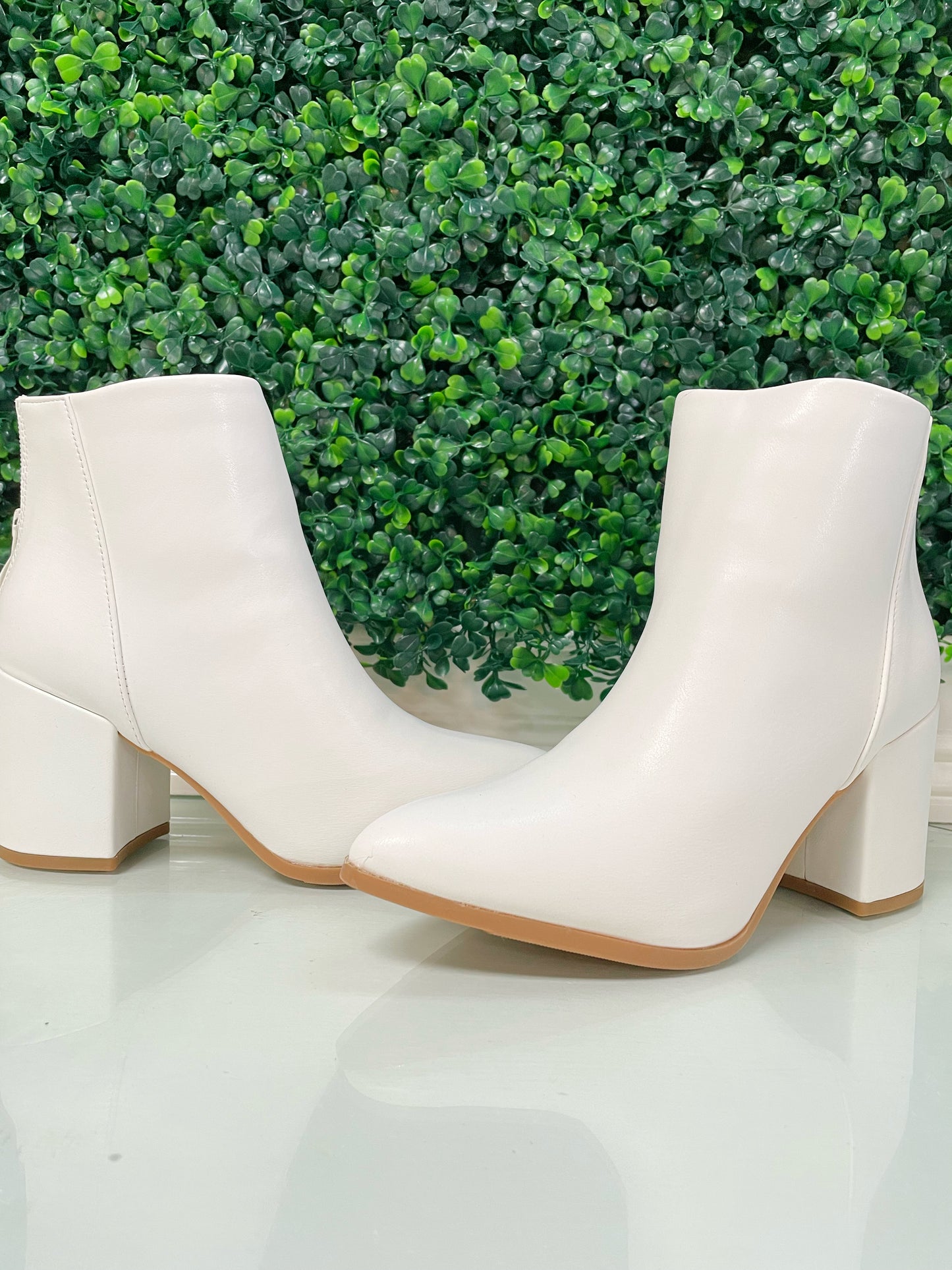 White block heel ankle booties with tan bottoms