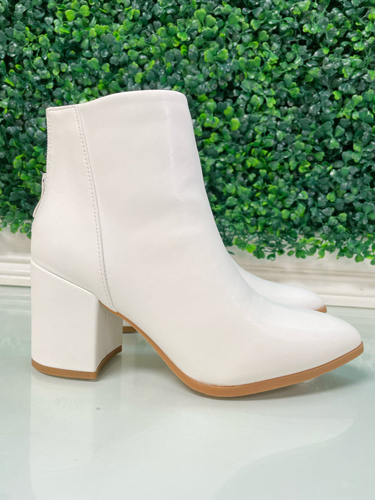 White block heel ankle booties with tan bottoms