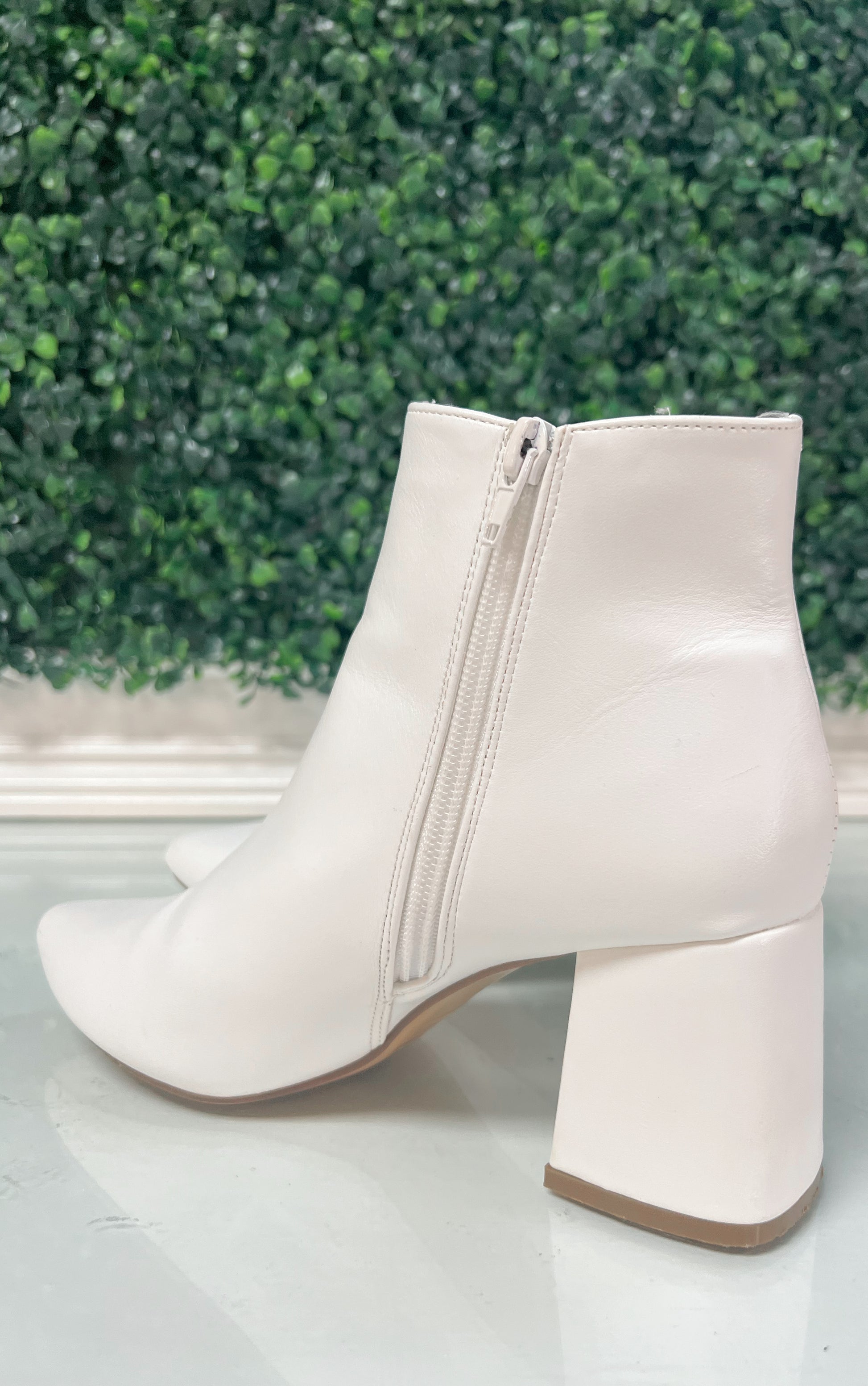 White heeled ankle booties with inside zipper