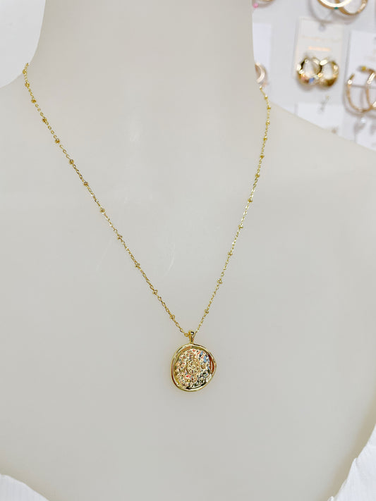 Gold necklace with unique compass coin design