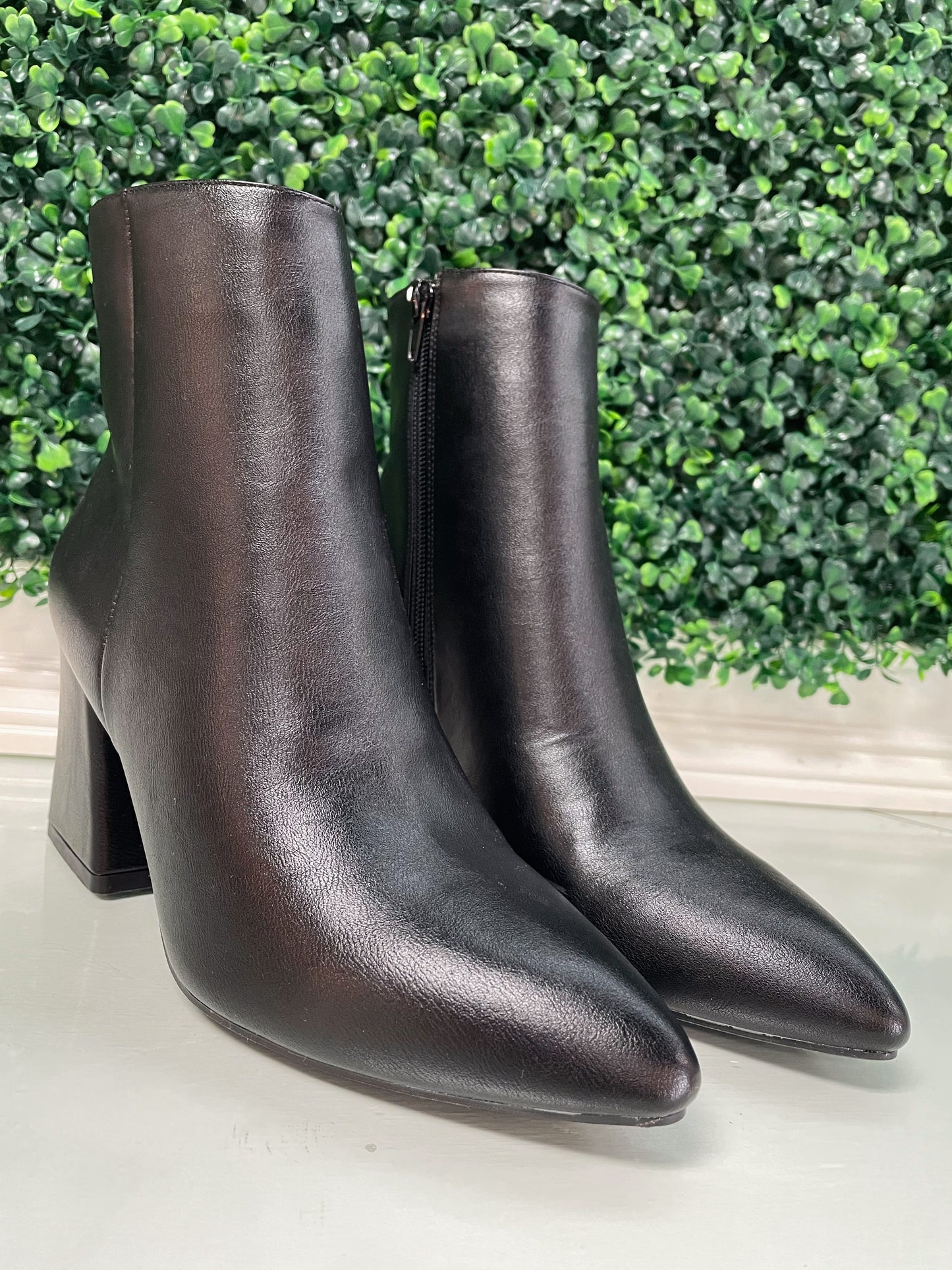 Black heeled ankle booties with inside zipper