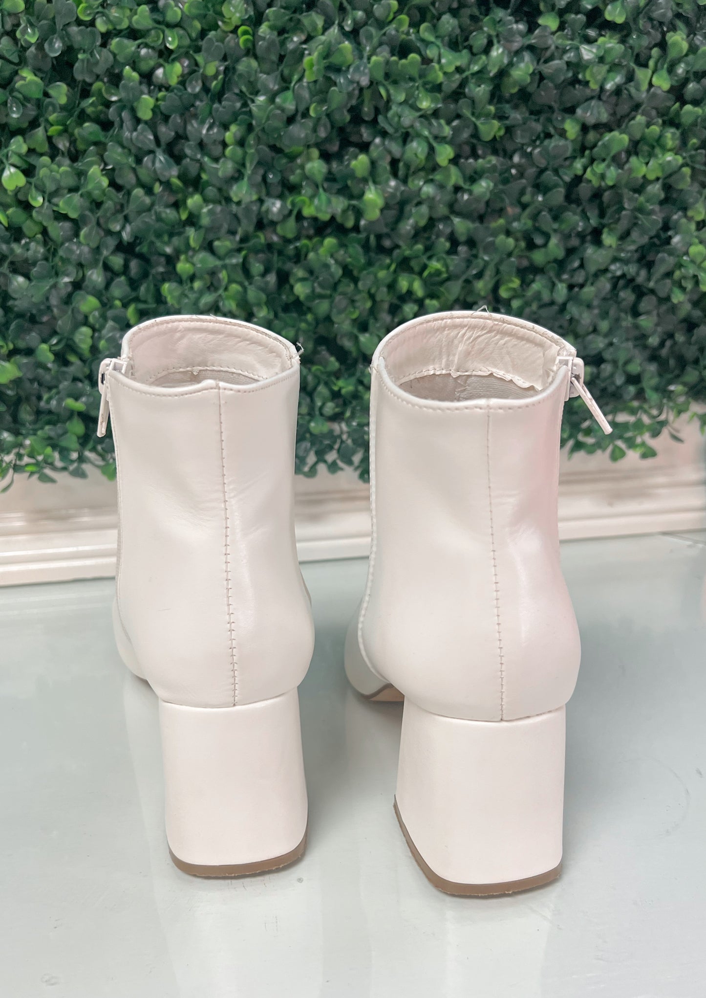 White heeled ankle booties with inside zipper