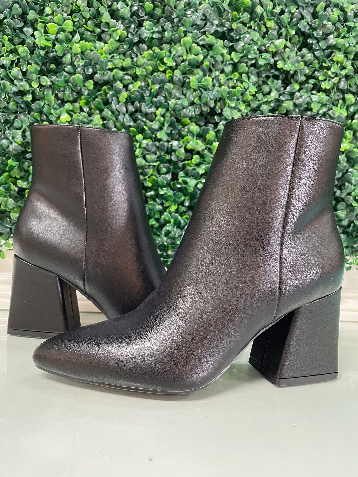 Black heeled ankle booties with inside zipper