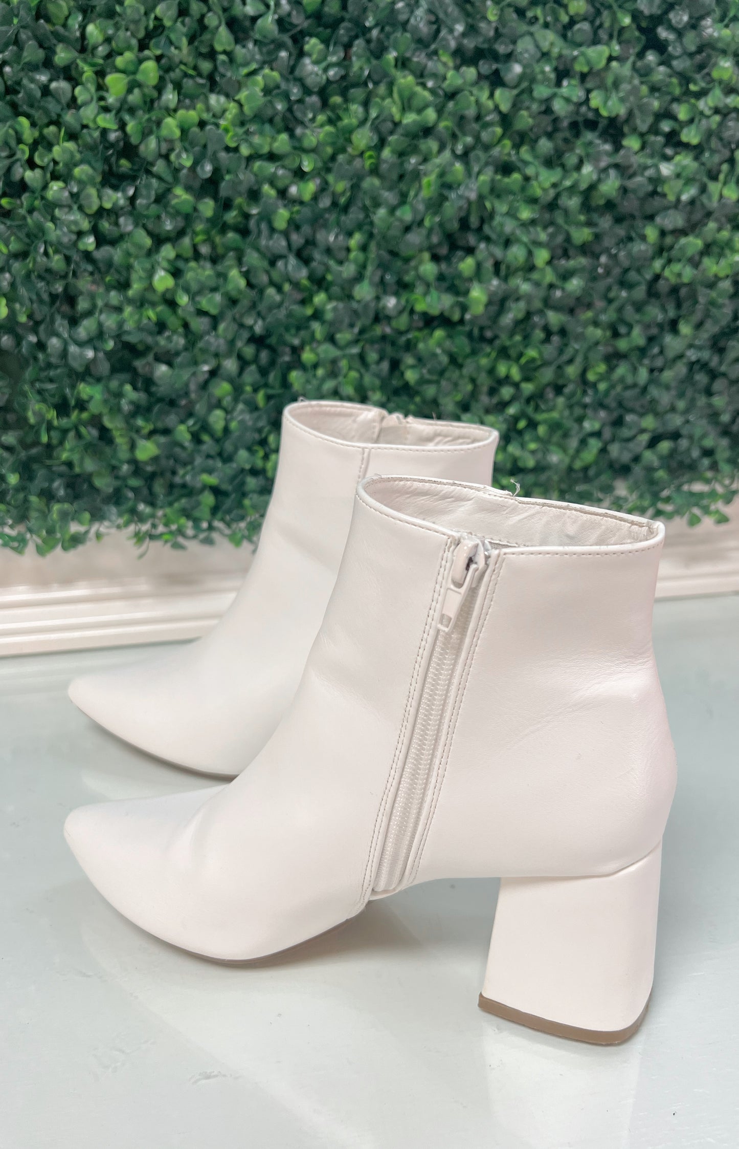White heeled ankle booties with inside zipper