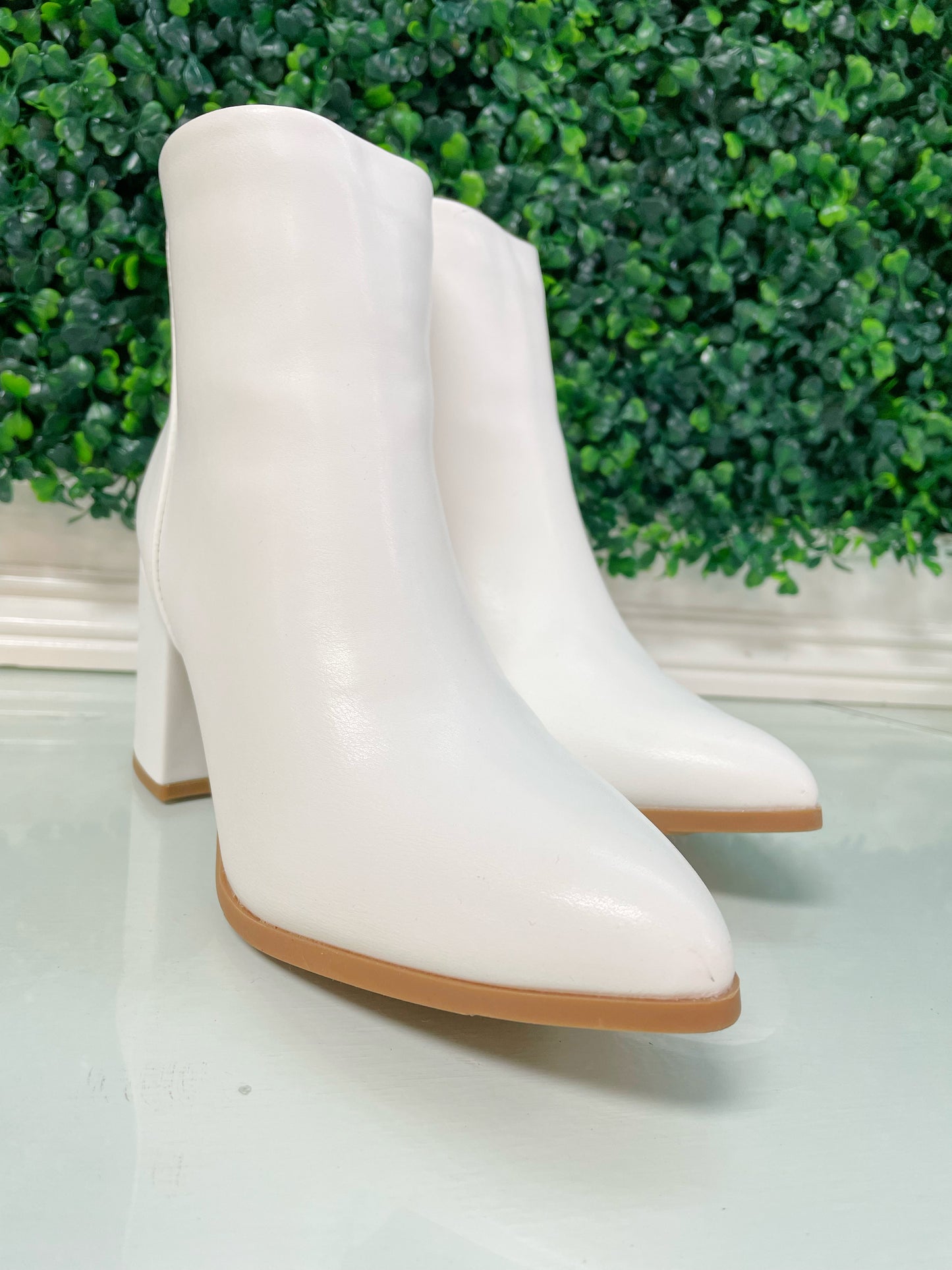 White block heel ankle booties with tan bottoms