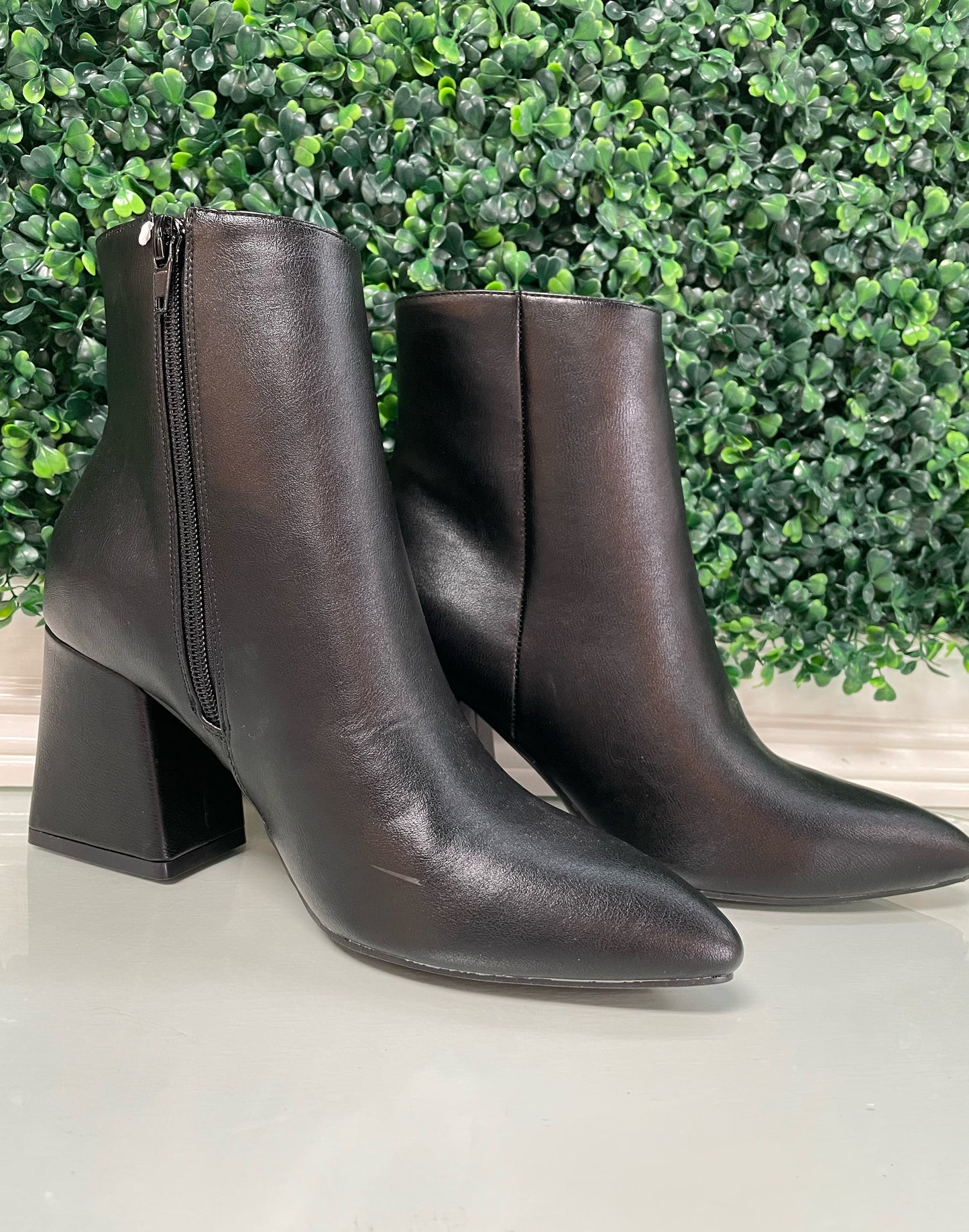 Black heeled ankle booties with inside zipper