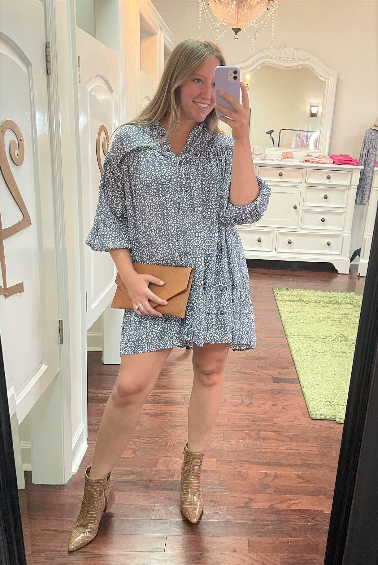 Brown faux crocodile ankle booties with zipper paired with brown clutch and white and blue animal print shirt dress