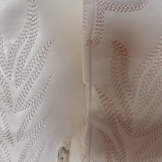 Tall white cowboy boots with embroidered detailing