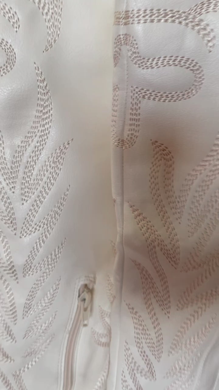 Tall white cowboy boots with embroidered detailing