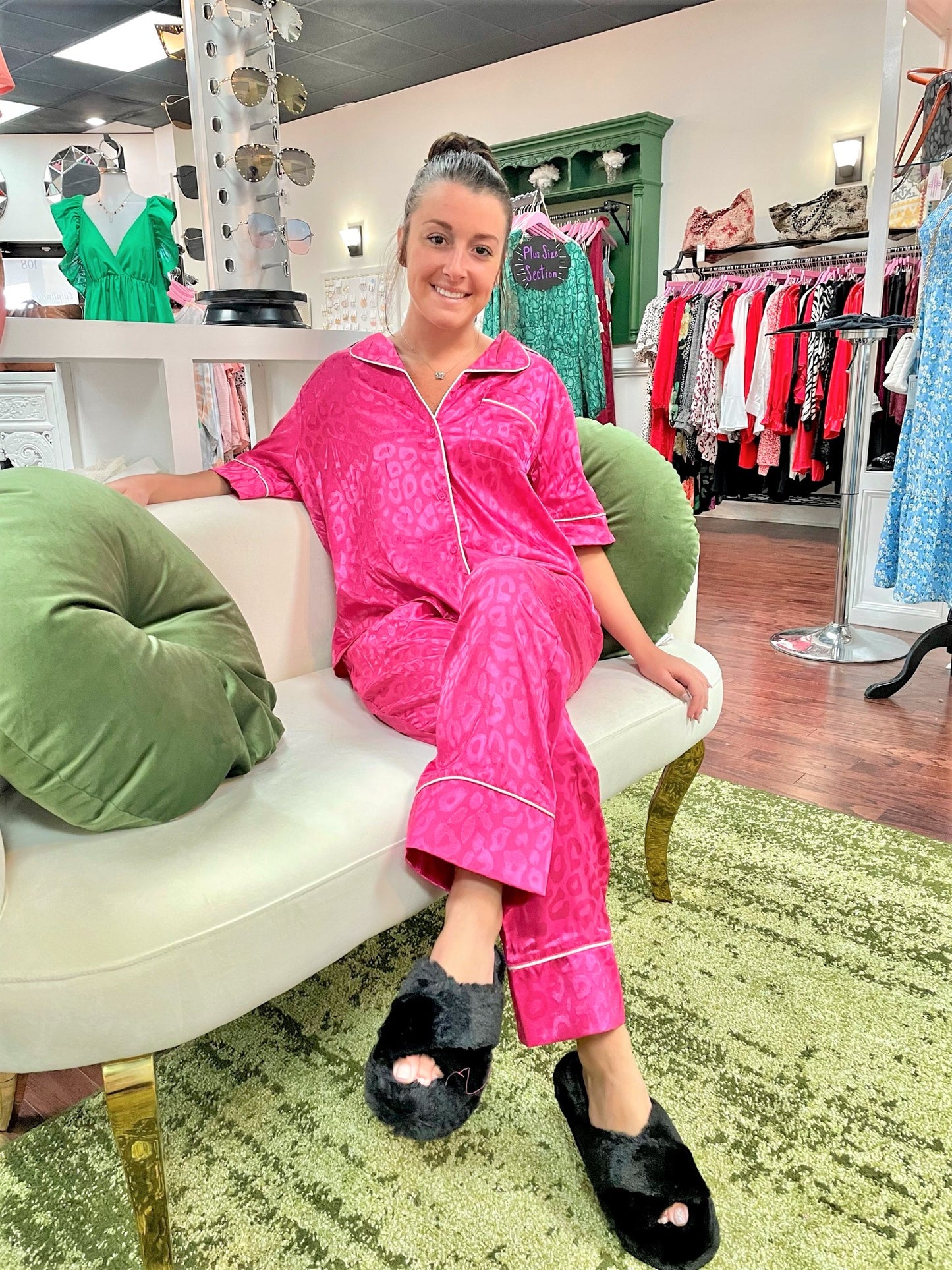 Black fuzzy open-toe platform slippers paired with pink satin pajama set