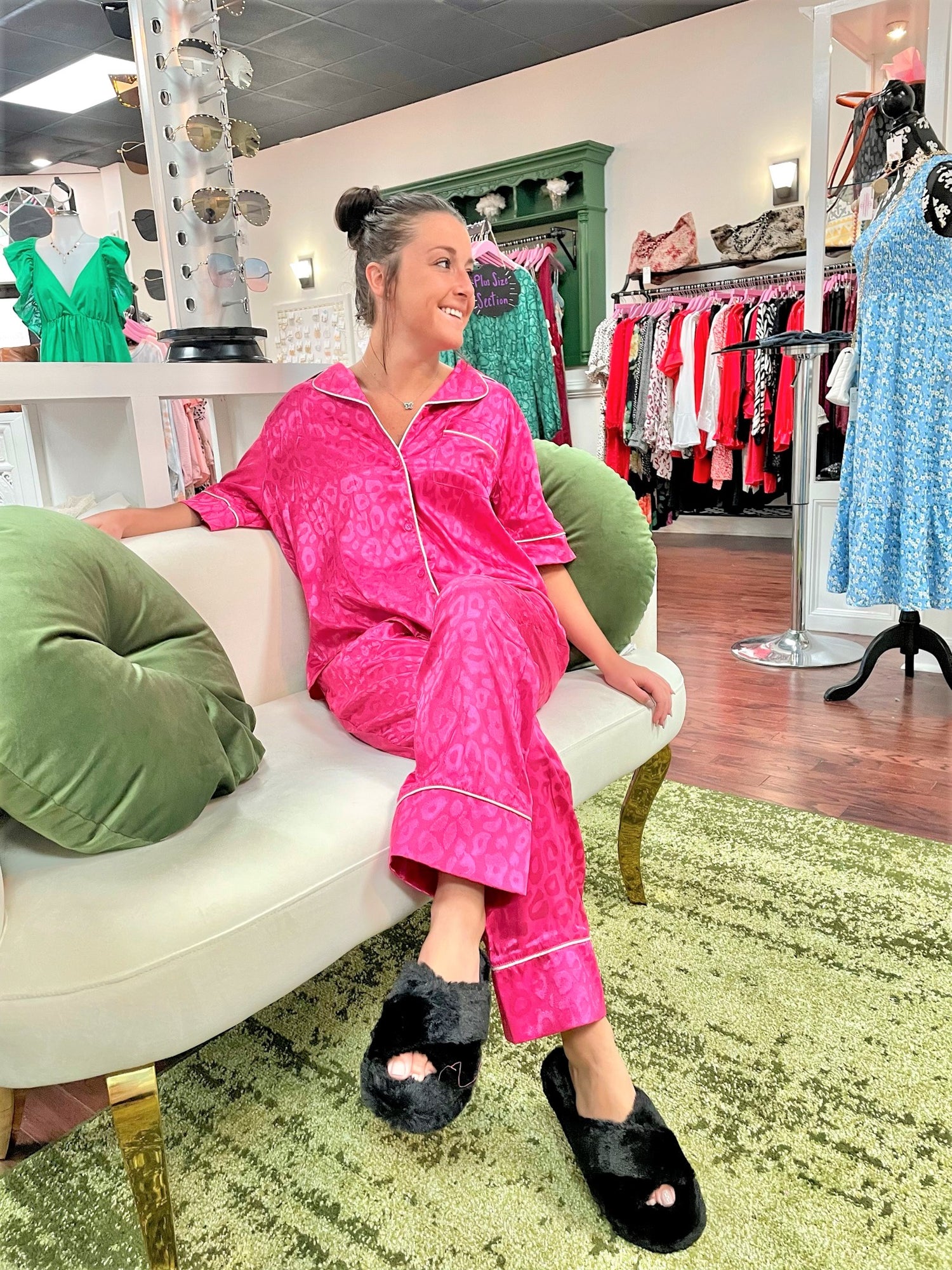 Black fuzzy open-toe platform slippers paired with pink satin pajama set