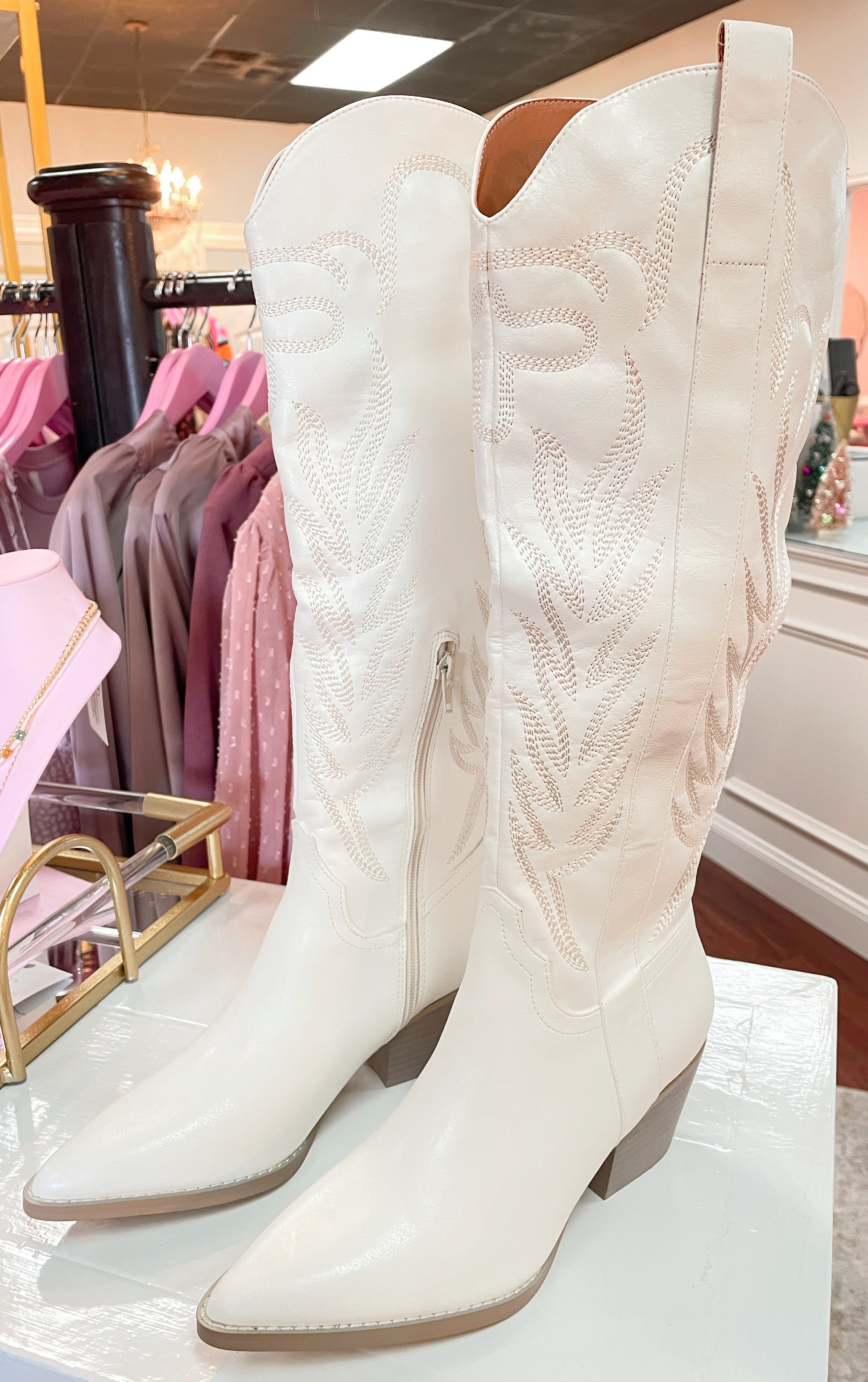 Tall white cowboy boots with embroidered detailing