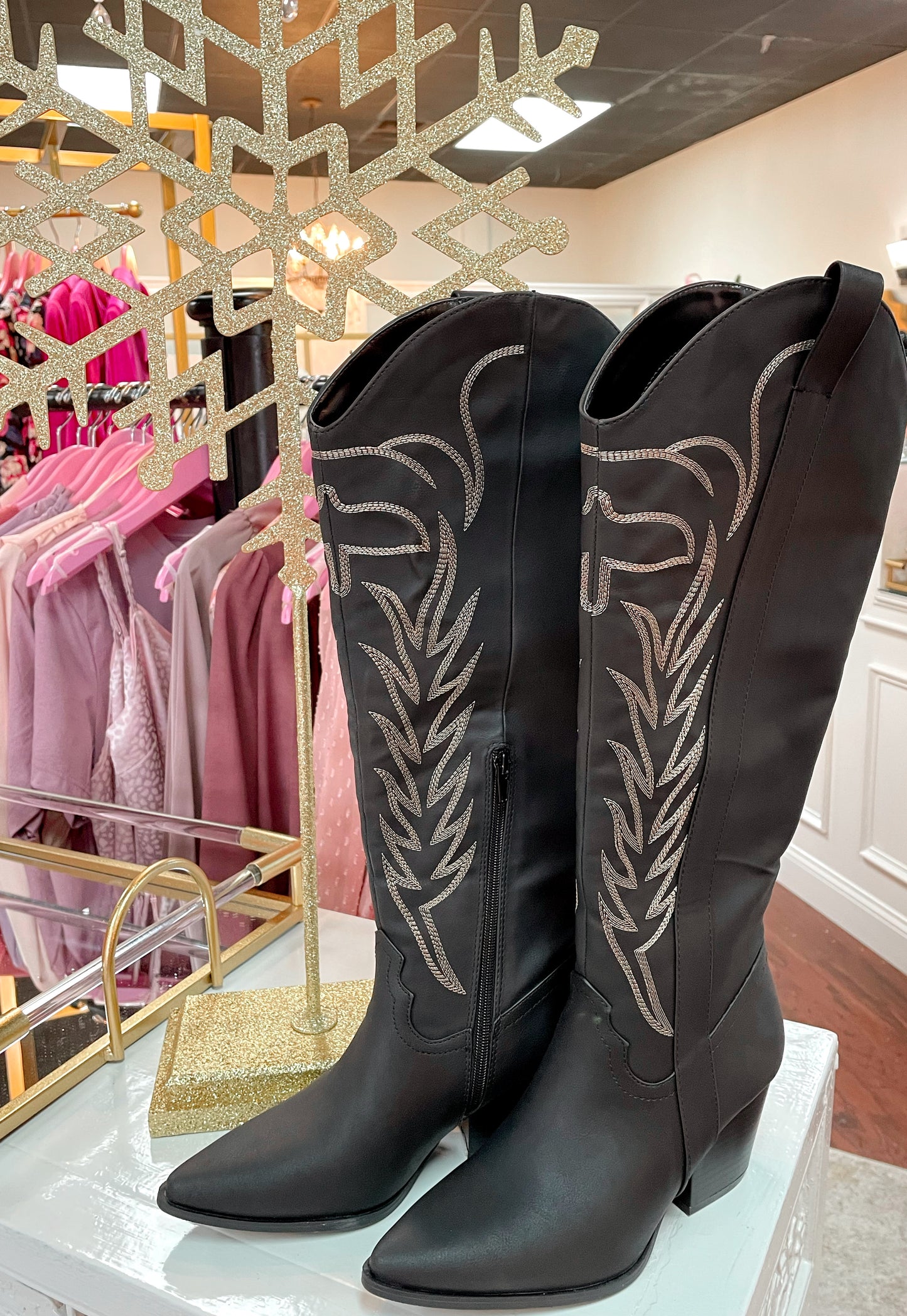 Tall black cowboy boots with embroidered detailing