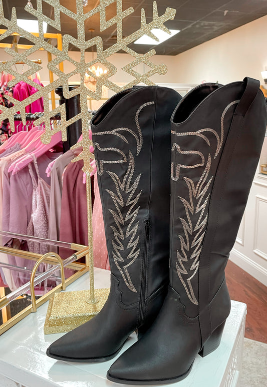 Tall black cowboy boots with embroidered detailing